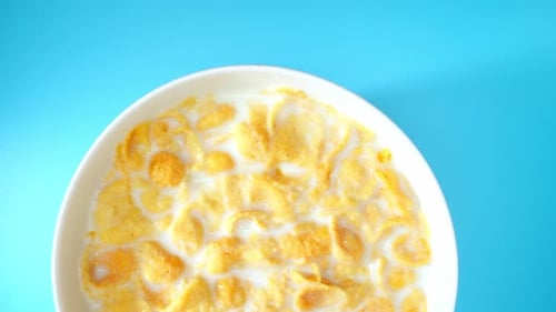 Top view of Appetizing corn flakes mixed with milk