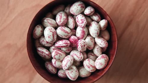 Cranberry Beans Spinning Borlotti Bean Pods in Wooden Bowl Top View Stylish Modern Food Background