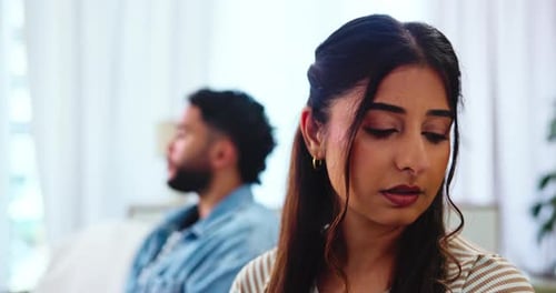 Couple, woman and frustrated on sofa after fight, disagreement and toxic relationship in lounge