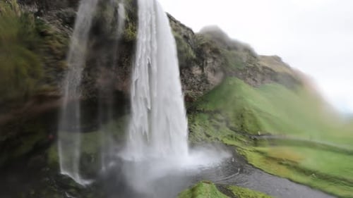 Seljalandsfoss waterfall in cloudy weather, Iceland, wet camera from water droplets