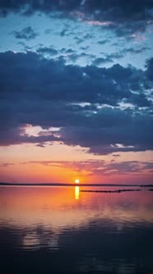 Vertical View of Sunset Reflection on Calm Water