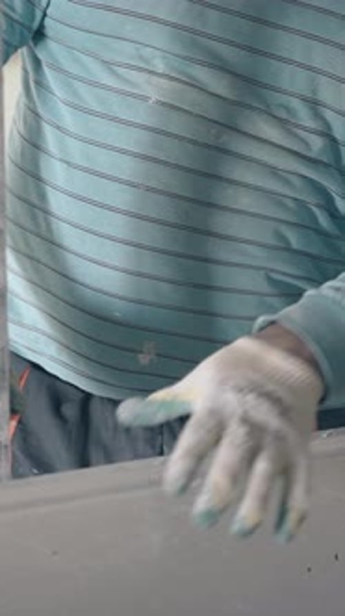 Construction Worker Leveling Plastered Wall Indoors