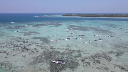 Top view or aerial view of beautiful clear water and white beach with fisherman's boats on summer tr