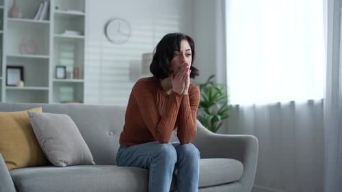 Young Woman Experiencing Mental Distress on Couch