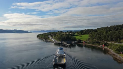Aerial shot of loaded car ferry reaching Solsnes, Norway