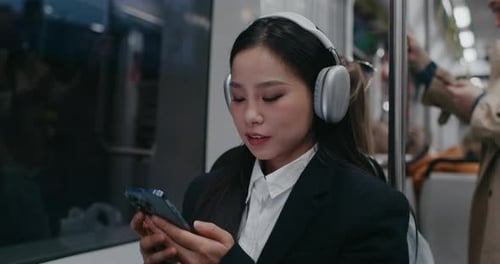 Chinese Girl Coming Back Home From Work or University in Bus or Train Wearing Black and White
