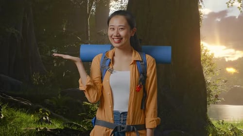 Asian Female Hiker Smiling And Pointing To Side While Exploring Forest Nature