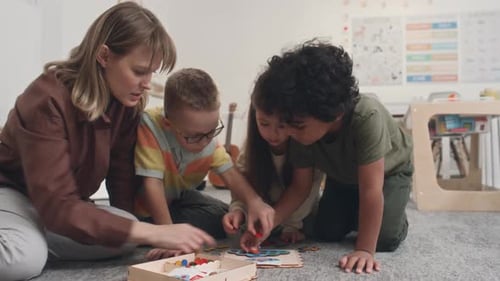 Teacher and Children Play Matching Game in Classroom
