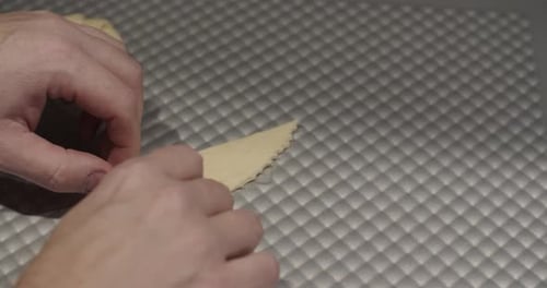 Close up of a Baker Making Dough Into Croissants.