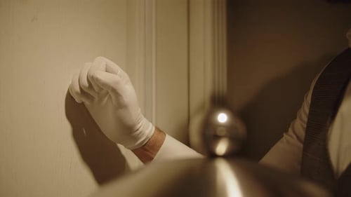 Gloved Hand Knocks on a Door