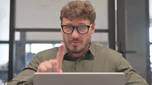 Close up of Middle Aged Man with Rejection Gestures while Using Laptop