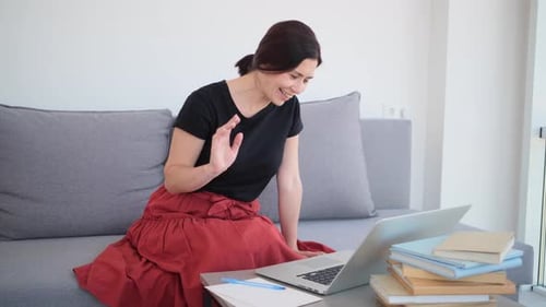 Woman Video Calling on Laptop at Home