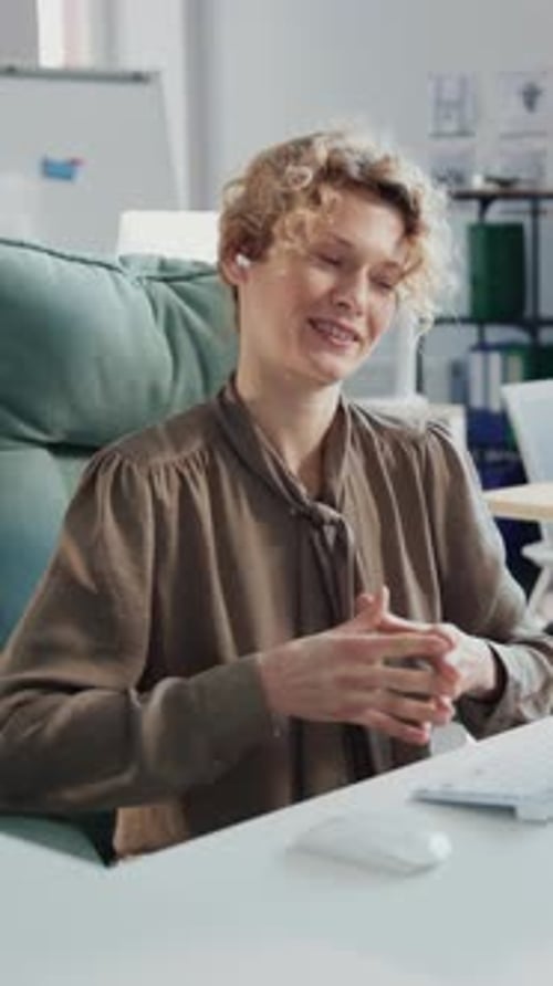 Woman talking during a Virtual Meeting at Desk