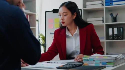 Business Professionals Reviewing Documents in Office Workplace