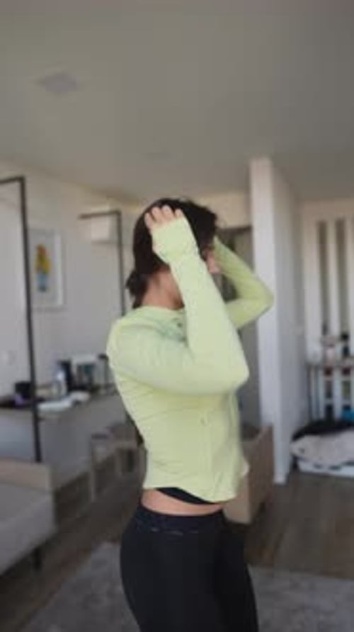 Woman Stretching Neck in Home Living Room