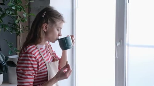 Woman Eating and Drinking by the Window