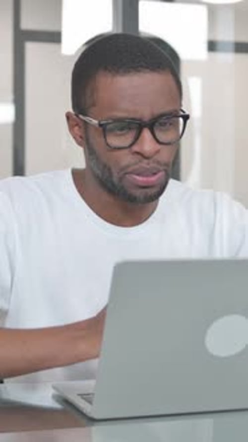 Young African Man Doing Video Chat in Office, vertical video