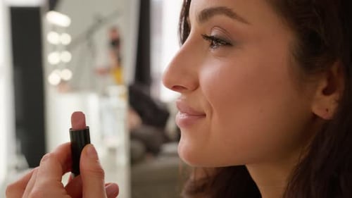 Glad Cheerful Caucasian Woman Model Girl Applying Nude Lipstick Lips Doing Makeup Beauty Routine