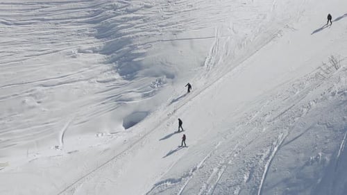 A Snowboarders and Skiers are Riding Together on a Ski Slope on a Ski Resort's Mountainside Extreme