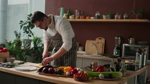 Male Chef Cutting Vegetables in Kitchen
