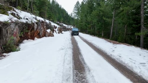 Aerial View of Mountain Twisted Road in the Winter and Driving Car Epic Snowy White Winter and Snow