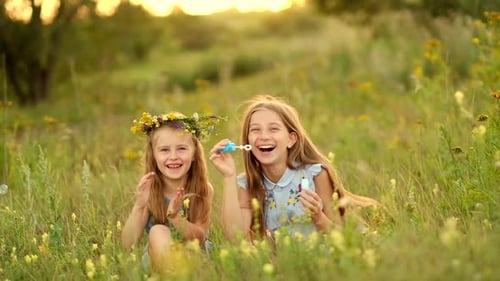 Litlte Girls Blowing Bubbles