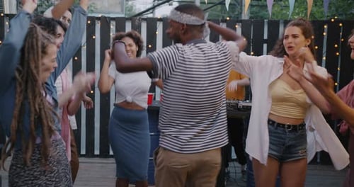 Young Adults Dancing at an Outdoor Party