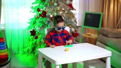 Young Boy Plays with Clay at Christmas time