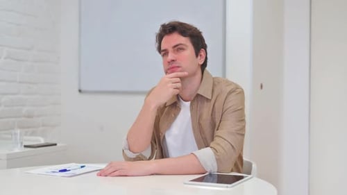 Thinking Young Man Brainstorming about Work