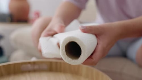 Woman Tearing Sheet From Roll of Paper Towel for Household Cleaning