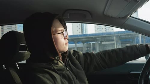 Side View Young Man Dancing in Parked Car Hand on Steering Wheel