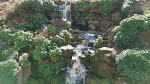 Aerial drone footage of a tall rocky waterfall in the Yorkshire Dales, Pennies. Moorland scene of a
