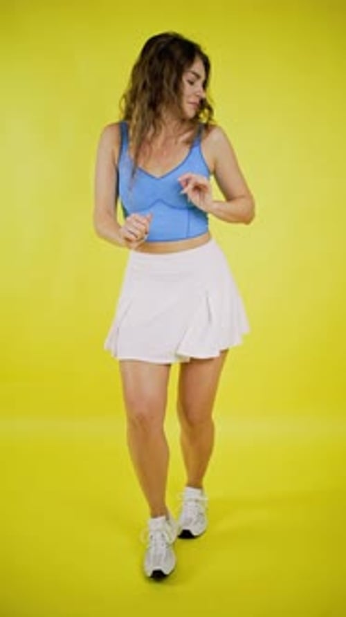 Young Woman Dancing Happily in a Studio