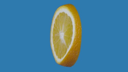 Rotating Orange Half Cut on Blue Background