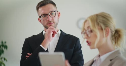 Business Colleagues Discuss in Office Meeting
