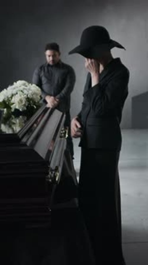 Woman Mourning Loss at Funeral with Flowers