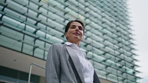 Stylish Woman in Gray Jacket Walking Down Stairs