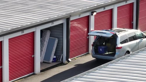 Aerial view of a self storage facility in United States, showing red roll-up garage units, an open
