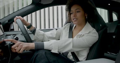 Woman interacting with a EV car touchscreen dashboard technology