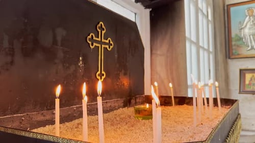 prayer, candle, cross in historical church