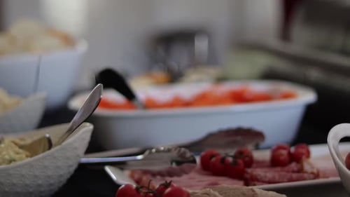 Assorted Buffet Dishes With Tongs and Spoons