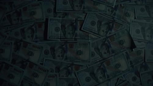 Many Dollars Illuminated Inspection Beam Top View Table Full of Money on Dark