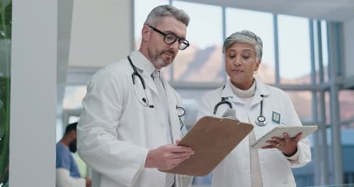 Doctors Discussing Patient Care in Hospital Setting