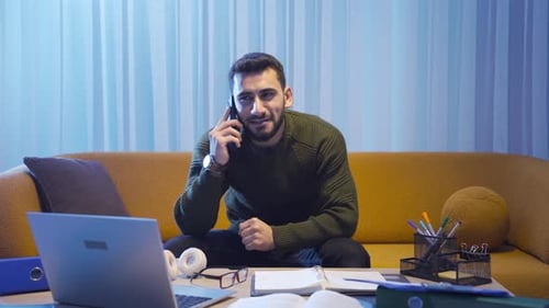 Man Talking on Cell Phone at Home