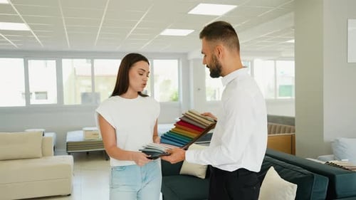 Woman Choosing Fabric Samples in Furniture Store