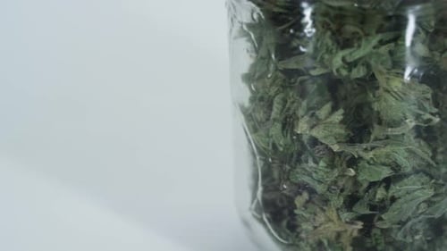 Close Up of Glass Jar with Dried Herbs