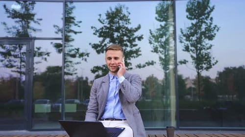 Young Adult Male Talking on Cell Phone Outdoors