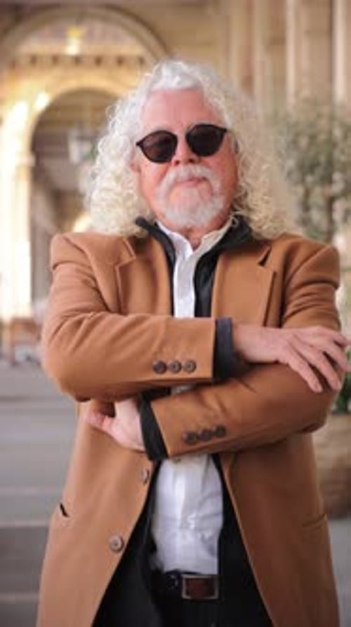 Stylish Senior Man Standing Confidently in Urban Setting