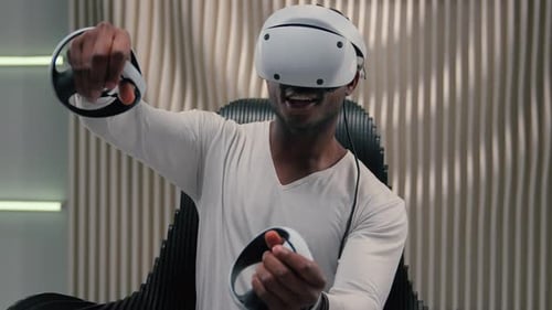 Man Immersed in Virtual Reality Gaming at Home