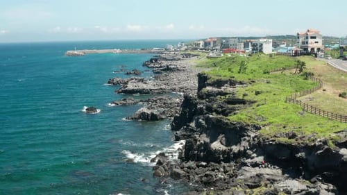 Drone view of Jeju sea, clear sky, and horizon.